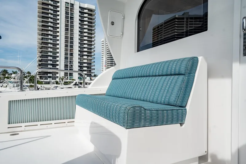 Slide: The Image of Blue cushioned seating on 2012 Hatteras 80 Motor Yacht deck, with cityscape background. - 37