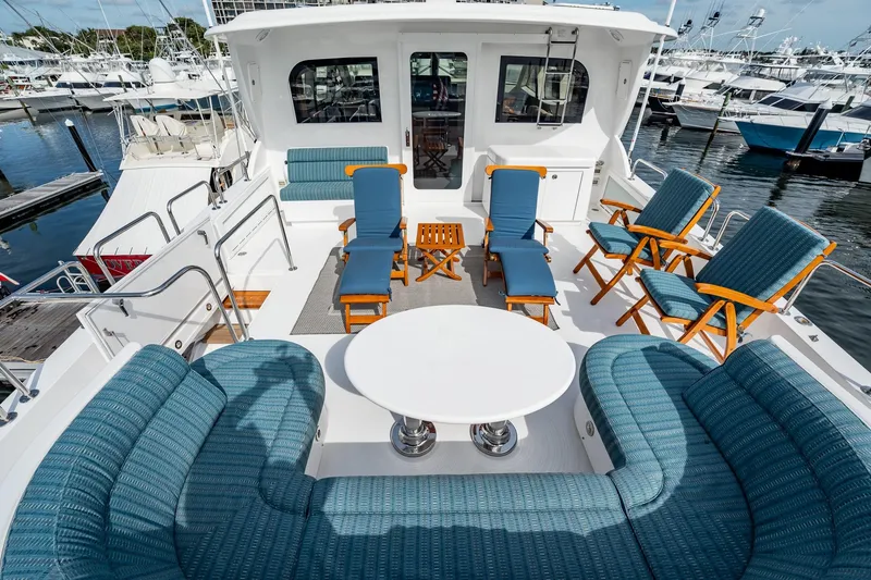 Slide: The Image of Spacious deck of 2012 Hatteras 80 Motor Yacht with elegant seating and marina view. - 40