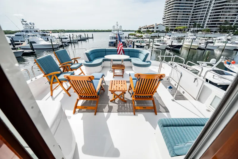 Slide: The Image of Luxurious 2012 Hatteras 80 Motor Yacht deck with seating, docked at marina. - 46