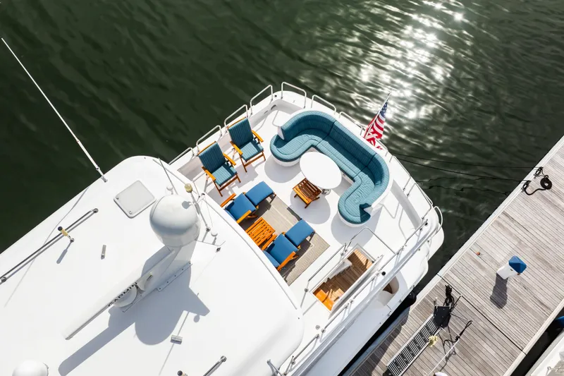 Slide: The Image of Aerial view of 2012 Hatteras 80 Motor Yacht deck with seating and American flag. - 5