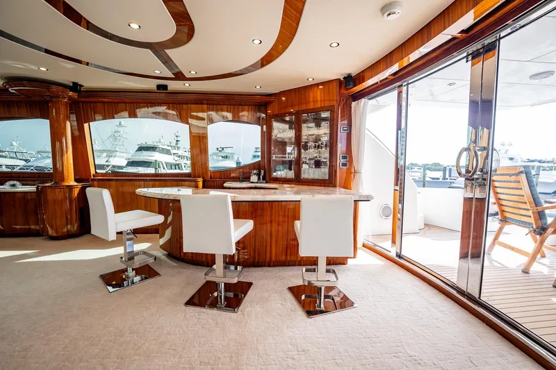 Slide: The Image of Luxurious interior of 2012 Hatteras 80 Motor Yacht with elegant seating and wooden accents. - 51
