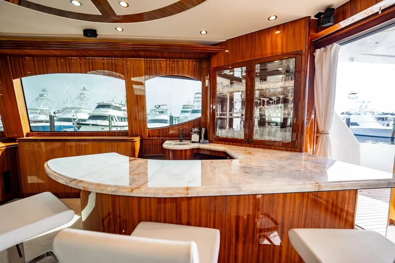 Slide: The Image of Luxurious interior of 2012 Hatteras 80 Motor Yacht with elegant bar and marina view. - 52