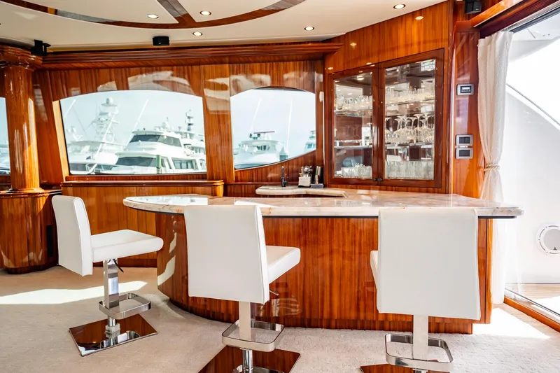 Slide: The Image of Luxurious interior of 2012 Hatteras 80 Motor Yacht with elegant bar and seating. - 53