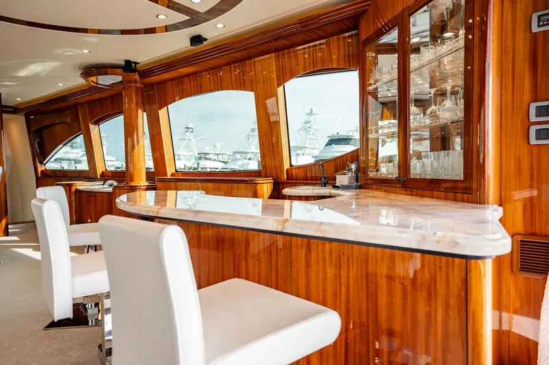 Slide: The Image of Luxurious interior of 2012 Hatteras 80 Motor Yacht with elegant wood finish and marble bar. - 55