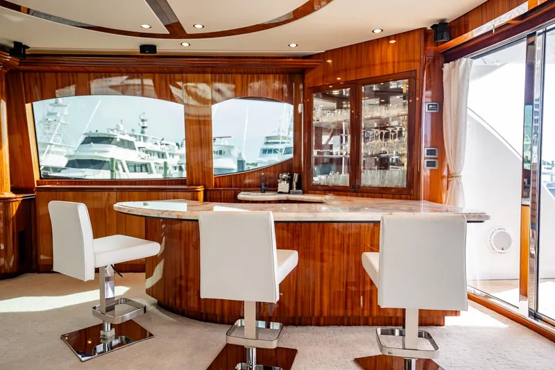 Slide: The Image of Luxurious interior of 2012 Hatteras 80 Motor Yacht with elegant bar and seating area. - 56