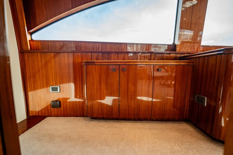 Slide: The Image of Luxurious wood interior of 2012 Hatteras 80 Motor Yacht, featuring polished cabinetry and plush carpeting. - 61
