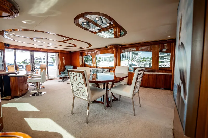 Slide: The Image of Luxurious interior of 2012 Hatteras 80 Motor Yacht with elegant dining area and panoramic windows. - 62