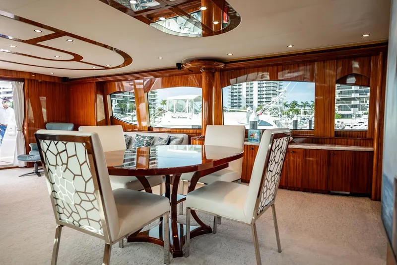 Slide: The Image of Luxurious interior of 2012 Hatteras 80 Motor Yacht with elegant dining area and panoramic windows. - 63