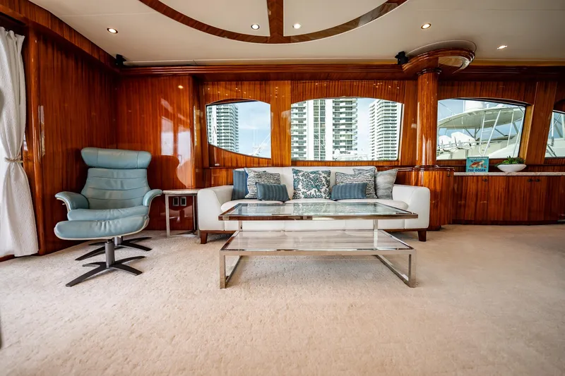 Slide: The Image of Luxurious interior of 2012 Hatteras 80 Motor Yacht with elegant seating and wood paneling. - 66