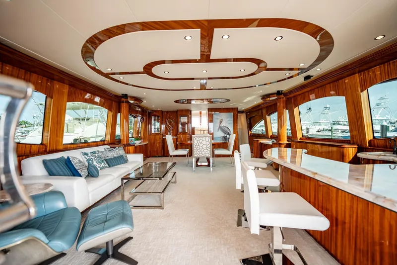 Slide: The Image of Luxurious interior of 2012 Hatteras 80 Motor Yacht with elegant seating and wood finishes. - 70