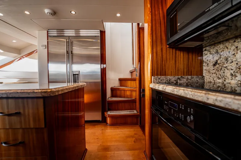 Slide: The Image of Luxurious kitchen interior of 2012 Hatteras 80 Motor Yacht with modern appliances and wooden finishes. - 74