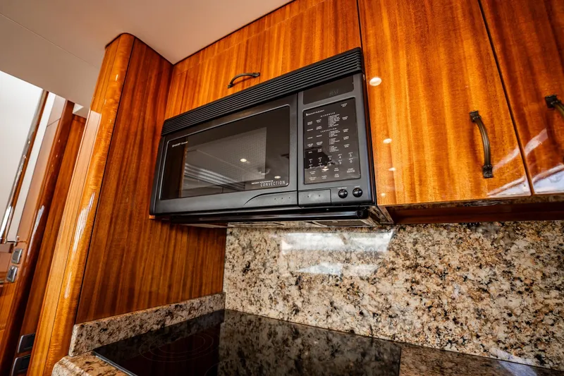 Slide: The Image of Luxury kitchen interior of 2012 Hatteras 80 Motor Yacht with microwave and granite countertop. - 75
