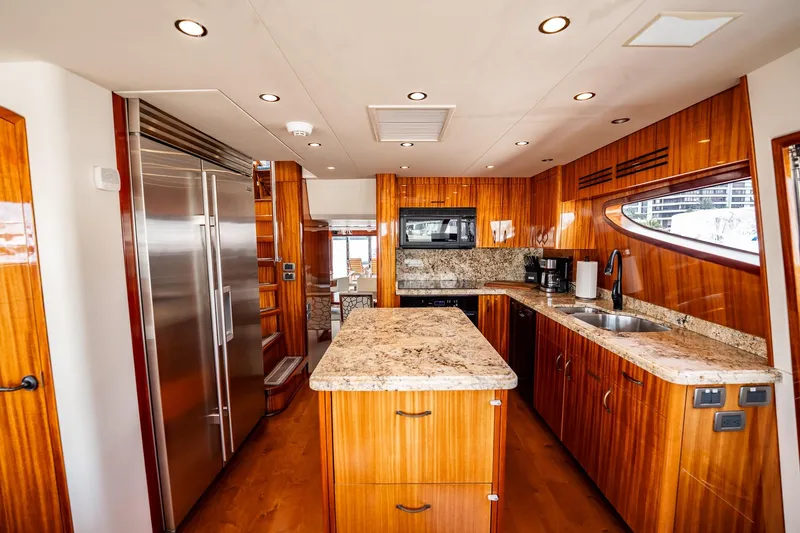 Slide: The Image of Luxurious kitchen interior of 2012 Hatteras 80 Motor Yacht with wood cabinetry and granite countertops. - 78