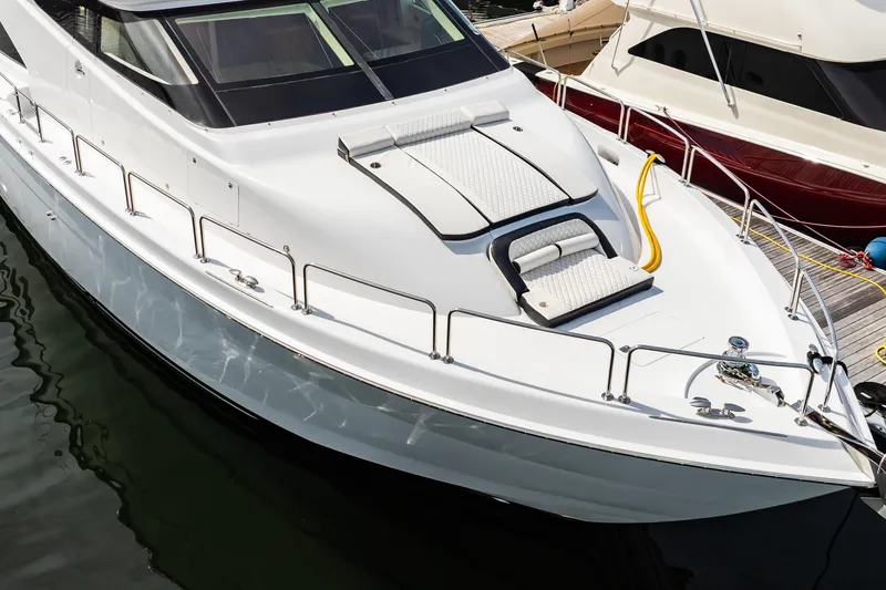 Slide: The Image of 2012 Hatteras 80 Motor Yacht docked, showcasing sleek design and spacious deck. - 8