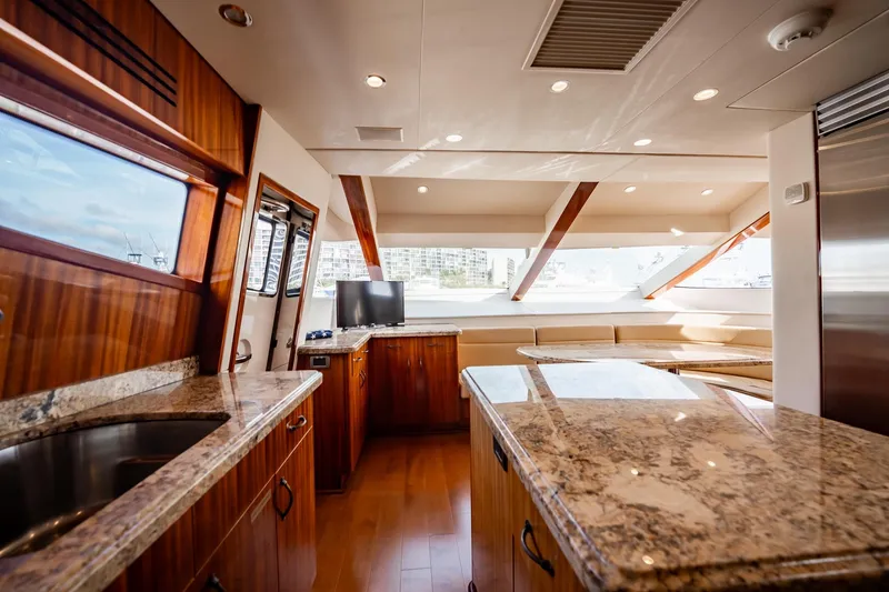Slide: The Image of Luxurious interior of 2012 Hatteras 80 Motor Yacht with granite countertops and wood finishes. - 83