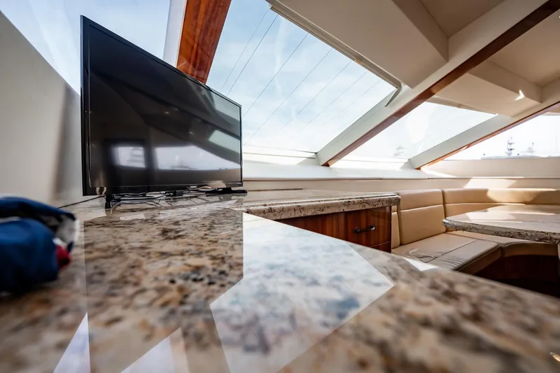 Slide: The Image of Luxurious interior of 2012 Hatteras 80 Motor Yacht with TV and elegant seating area. - 88