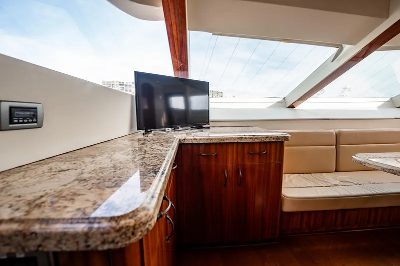Slide: The Image of Luxurious interior of 2012 Hatteras 80 Motor Yacht with TV and elegant seating area. - 91