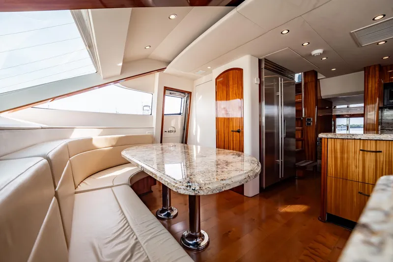 Slide: The Image of Luxurious interior of 2012 Hatteras 80 Motor Yacht with elegant dining area and modern kitchen. - 92