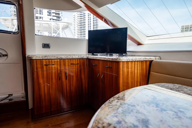 Slide: The Image of Interior of 2012 Hatteras 80 Motor Yacht with wooden cabinetry and TV. - 93