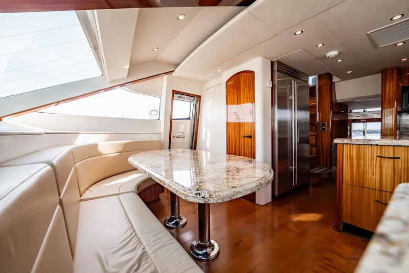 Slide: The Image of Luxurious interior of 2012 Hatteras 80 Motor Yacht with elegant dining area and modern kitchen. - 94