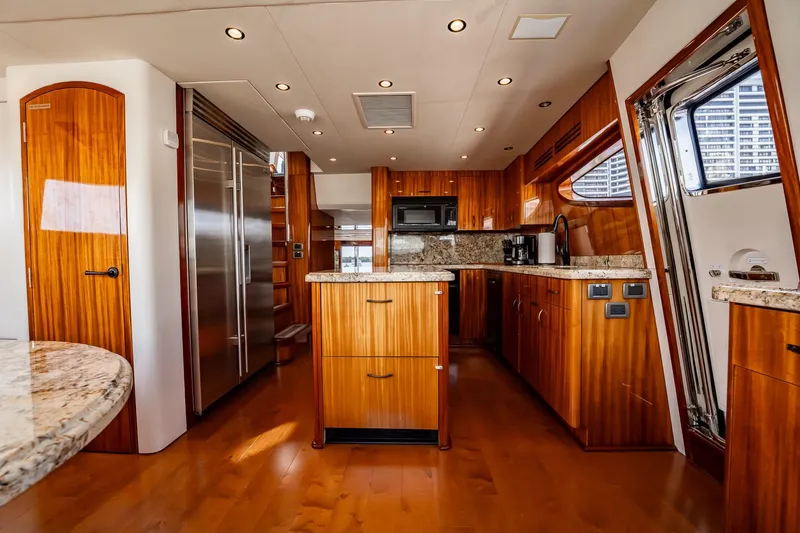 Slide: The Image of Luxurious kitchen interior of 2012 Hatteras 80 Motor Yacht with wood cabinetry and modern appliances. - 95