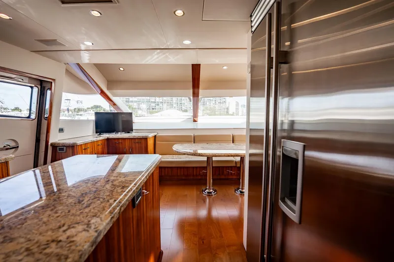 Slide: The Image of Luxurious interior of 2012 Hatteras 80 Motor Yacht with modern kitchen and seating area. - 96