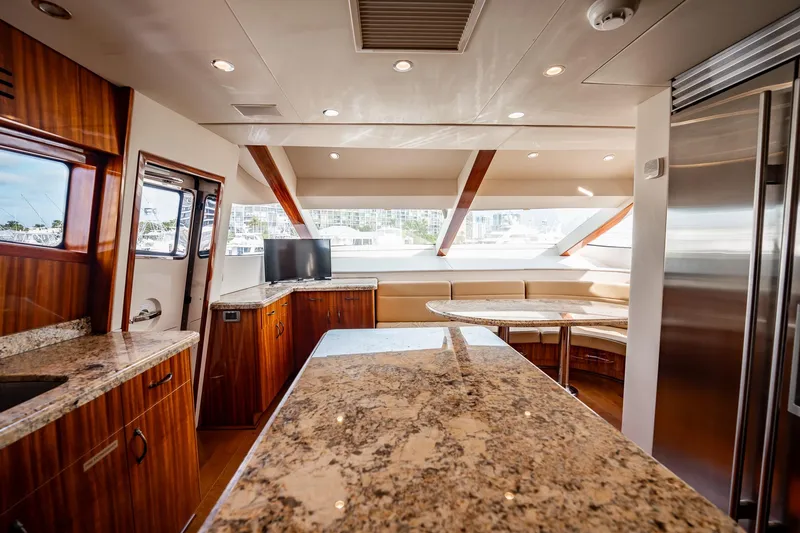 Slide: The Image of Luxurious interior of 2012 Hatteras 80 Motor Yacht with granite countertops and modern seating area. - 98