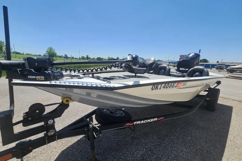 Slide: The Image of 2023 Tracker Pro Team 195 TXW Tournament Edition boat on trailer, sunny day. - 2