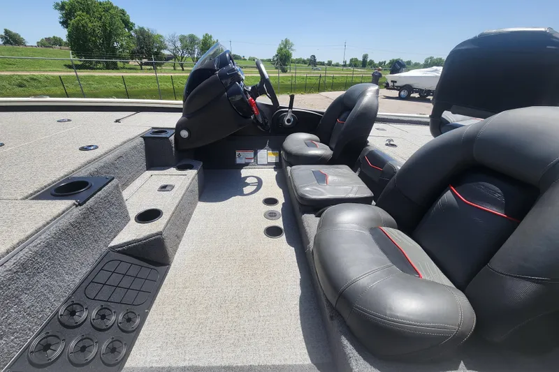 Slide: The Image of 2023 Tracker Pro Team 195 TXW Tournament Edition boat interior with seating and steering console. - 4