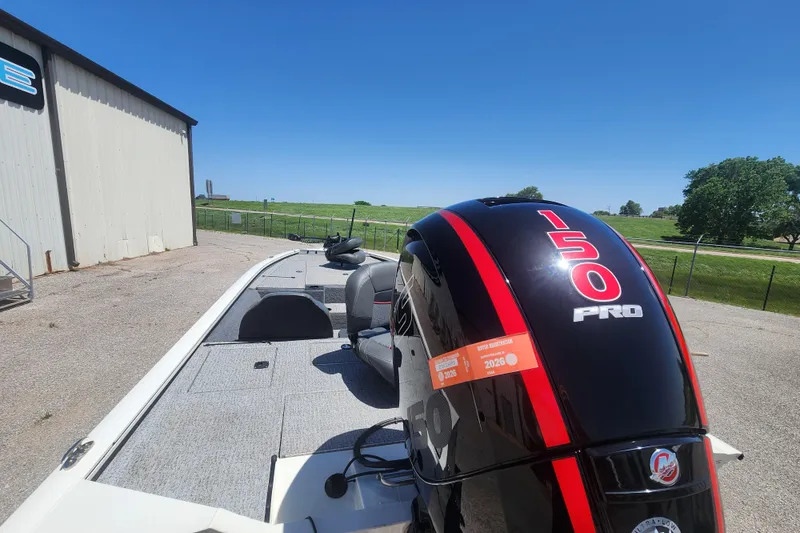 Slide: The Image of 2023 Tracker Pro Team 195 TXW Tournament Edition boat with 150 Pro engine, parked outdoors. - 7