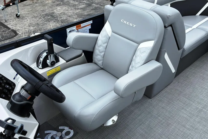 Slide: The Image of Captain's seat of 2025 Crest CLASSIC 220 SLC boat, featuring sleek gray upholstery. - 10
