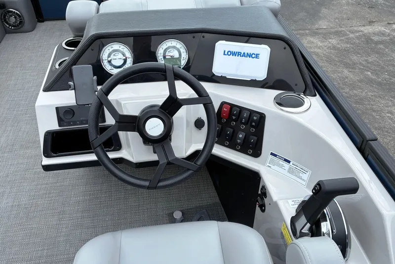 Slide: The Image of Steering console of 2025 Crest CLASSIC 220 SLC boat with gauges and controls. - 11