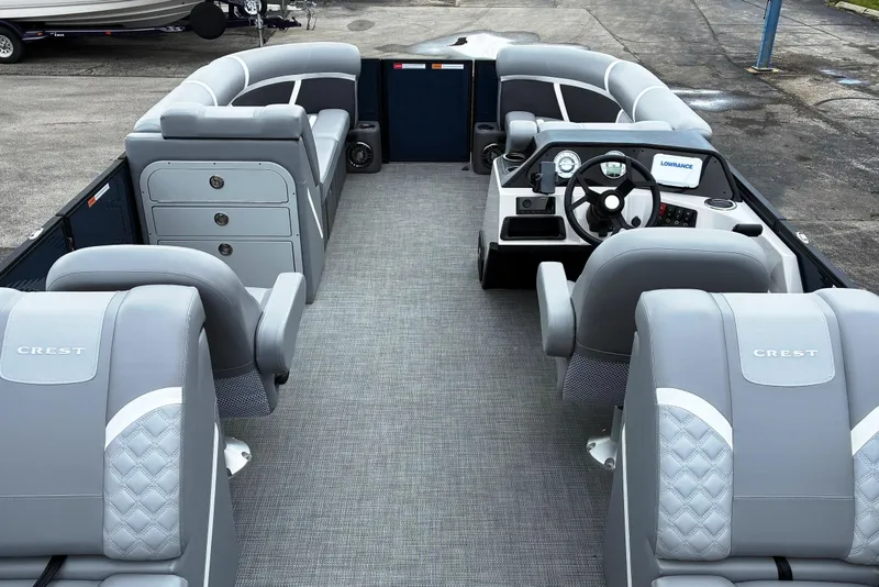 Slide: The Image of 2025 Crest CLASSIC 220 SLC pontoon boat interior with gray seating and modern dashboard. - 6