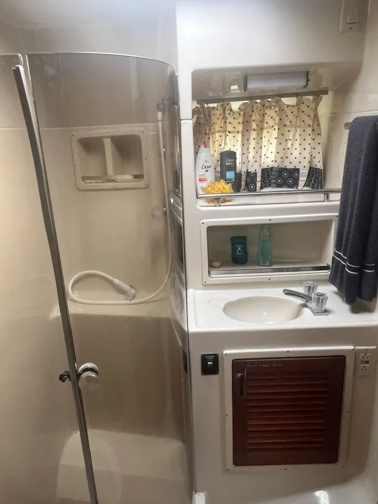 Slide: The Image of 1986 Tiara Yachts 36 Express bathroom with shower and sink. - 4