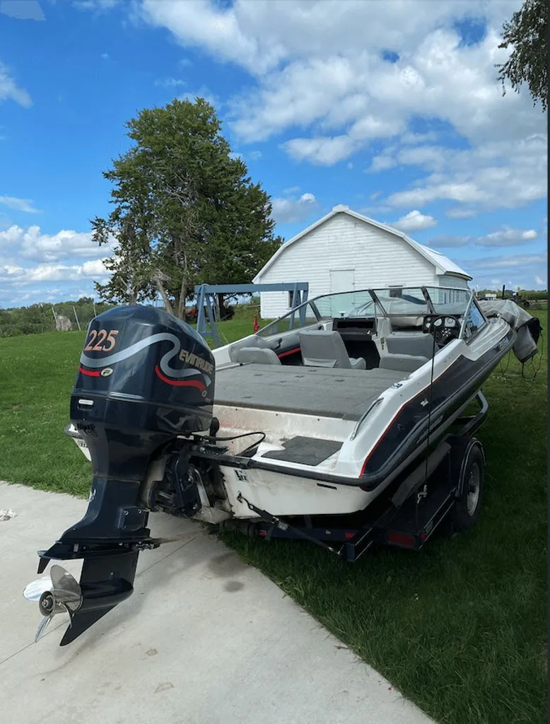 Slide: The Image of 1997 Stratos 290 SF boat with Evinrude 225 motor outdoors. - 2