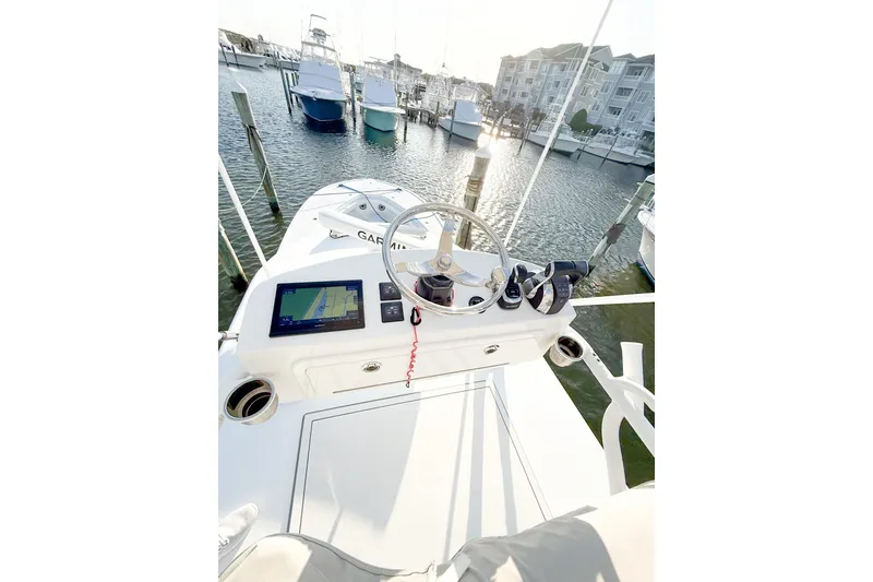 Slide: The Image of Helm of 2022 Onslow Bay 41 Tournament boat with navigation display, docked in marina. - 10