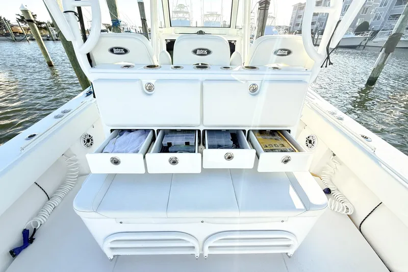 Slide: The Image of 2022 Onslow Bay 41 Tournament boat with open storage drawers, docked by the water. - 18