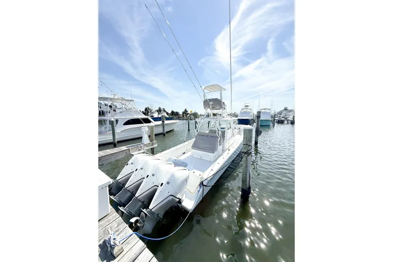 Slide: The Image of 2022 Onslow Bay 41 Tournament boat docked at marina under clear sky. - 2
