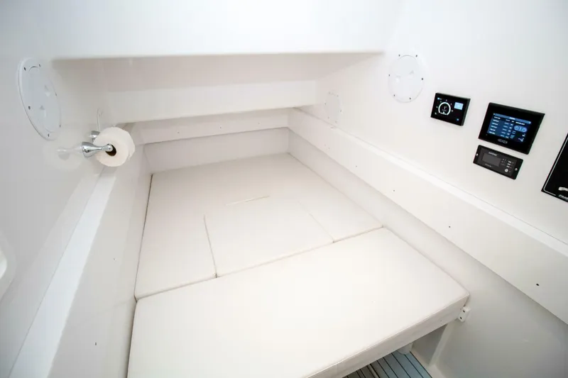 Slide: The Image of 2022 Onslow Bay 41 Tournament cabin interior with white bedding and control panels. - 26