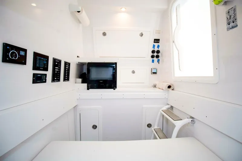 Slide: The Image of Interior of 2022 Onslow Bay 41 Tournament boat with control panels and seating. - 29
