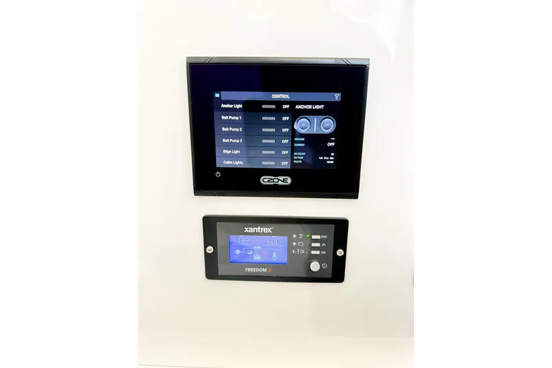 Slide: The Image of Control panels on a 2022 Onslow Bay 41 Tournament boat, featuring lighting and system management. - 30