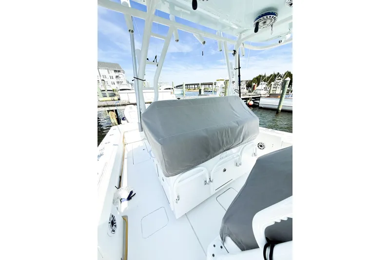 Slide: The Image of 2022 Onslow Bay 41 Tournament boat interior with covered seating at a marina. - 31