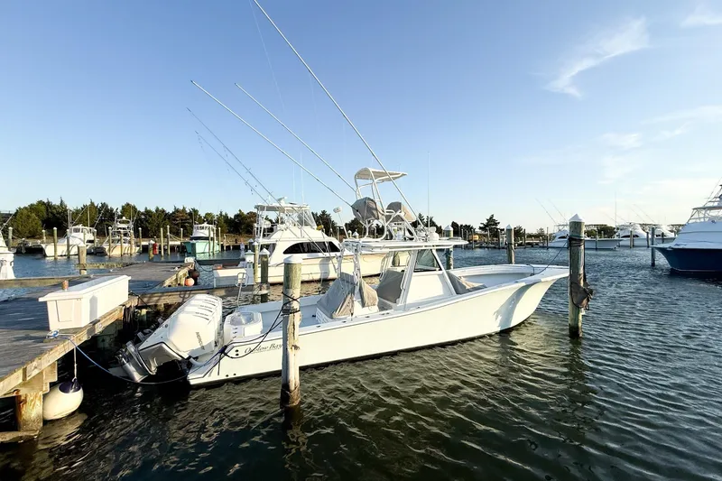 Slide: The Image of 2022 Onslow Bay 41 Tournament boat docked at marina under clear blue sky. - 36