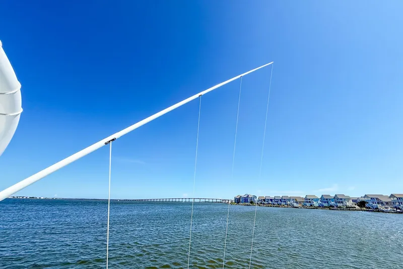 Slide: The Image of Onslow Bay 41 Tournament boat view with clear blue sky and coastal houses, 2022 model. - 37
