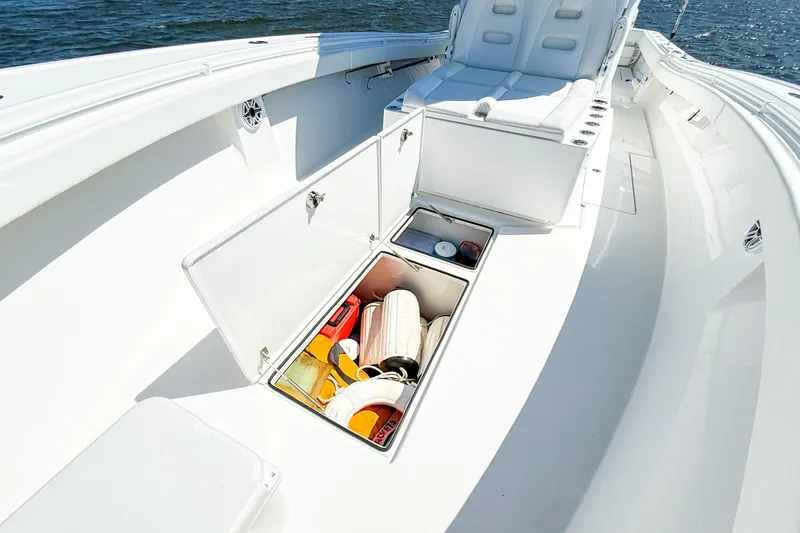 Slide: The Image of 2022 Onslow Bay 41 Tournament boat with open storage compartments and seating. - 39