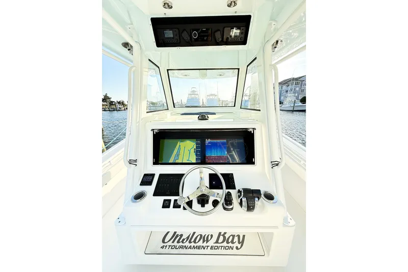 Slide: The Image of 2022 Onslow Bay 41 Tournament boat docked with triple outboard engines. - 43
