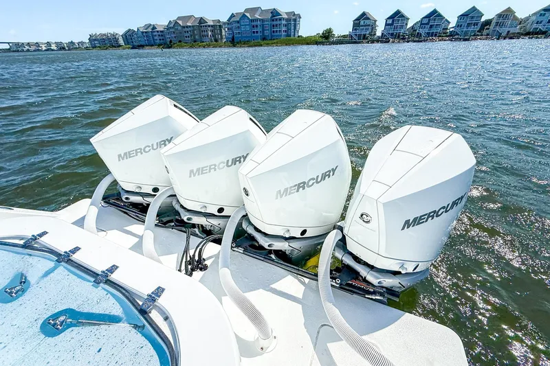 Slide: The Image of 2022 Onslow Bay 41 Tournament boat interior with covered seating at a marina. - 47