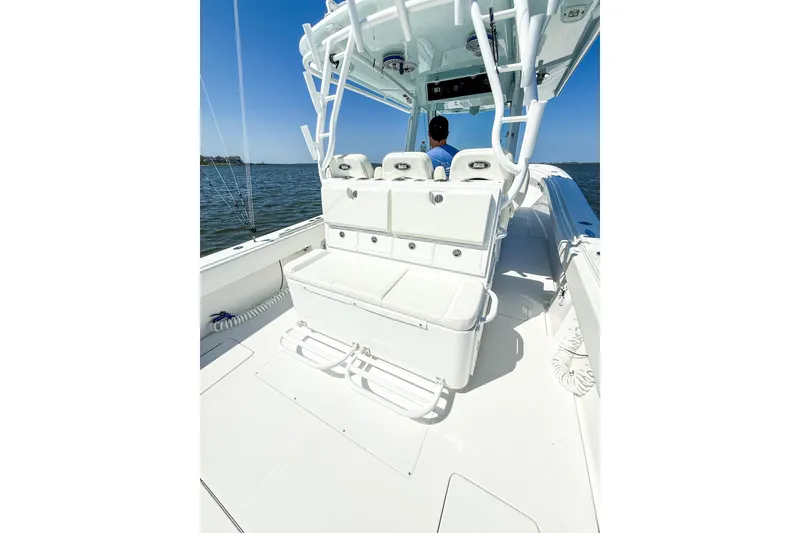 Slide: The Image of 2022 Onslow Bay 41 Tournament boat interior with covered seating and console. - 49