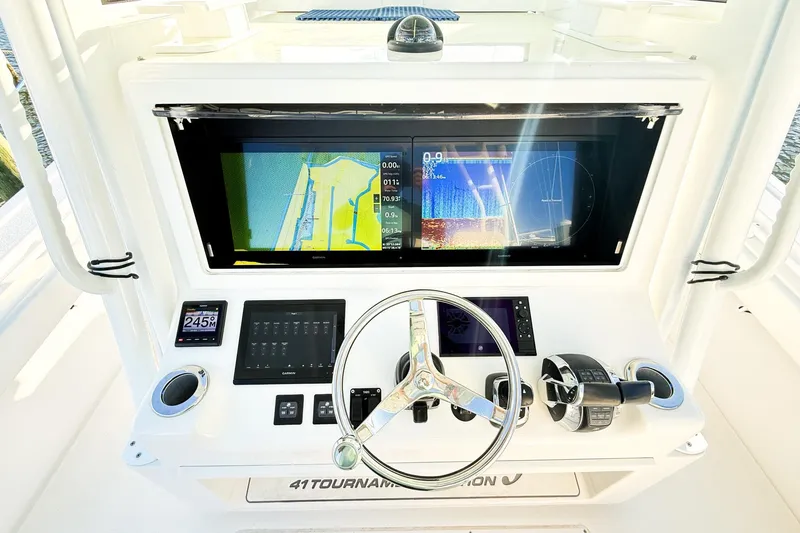 Slide: The Image of 2022 Onslow Bay 41 Tournament boat dashboard with navigation screens and controls. - 6