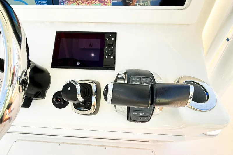 Slide: The Image of Control panel of 2022 Onslow Bay 41 Tournament boat with steering and navigation controls. - 9